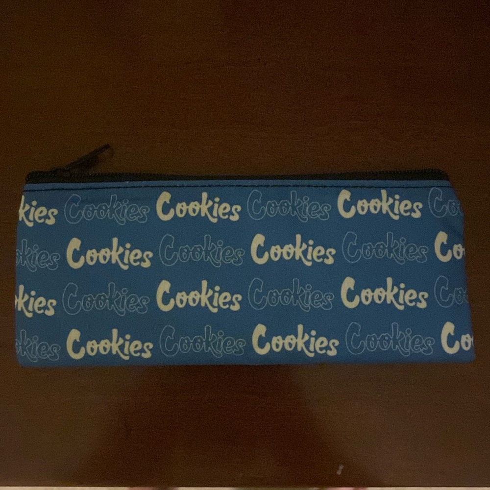 “Cookies” pouch. Blue and white, never been used. The pouch isn’t smell proof.